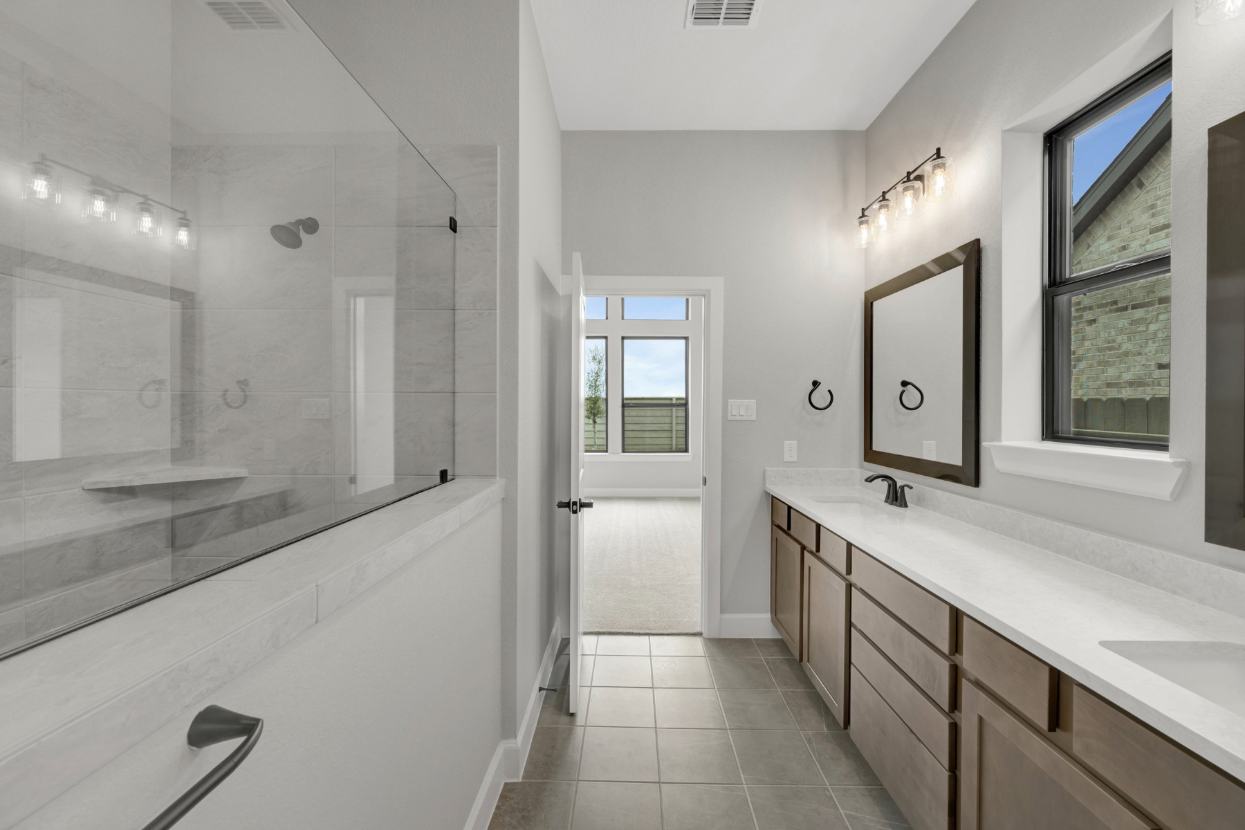 5407 Mango Blfs Street Manvel, TX 77578 - Photo 38 of 50 a spacious bathroom with a granite countertop sink mirror and a