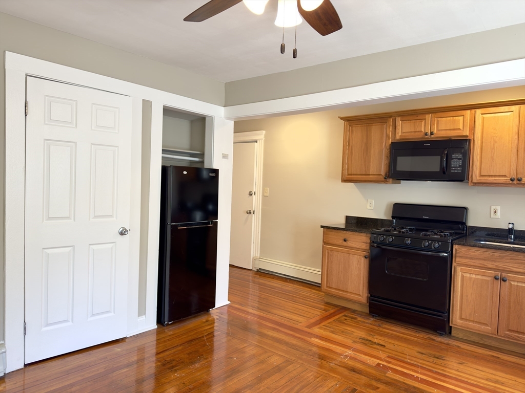 124 Green Street, Unit 201 Lynn, MA 01902 - Photo 2 of 5 a kitchen with stainless steel appliances granite countertop a stove and a refrigerator