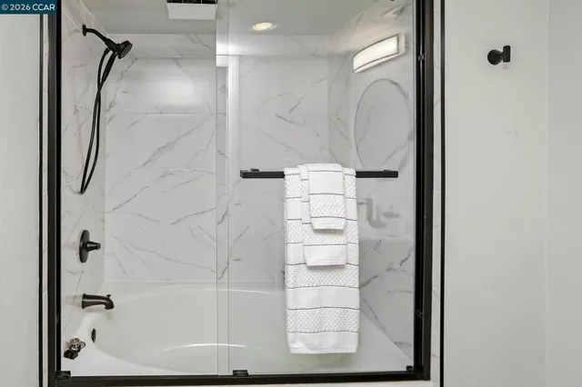 a bathroom with a shower and a sink