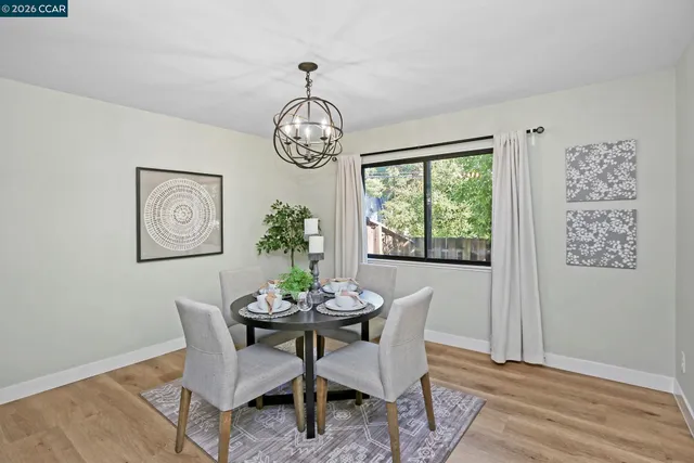 a view of a dining room with furniture window and wooden floor