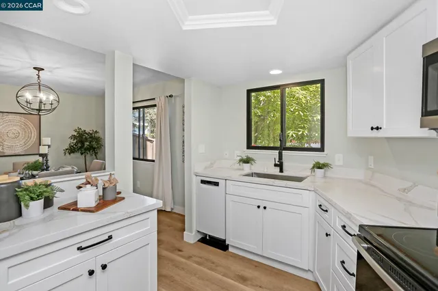 a kitchen with a sink cabinets and window