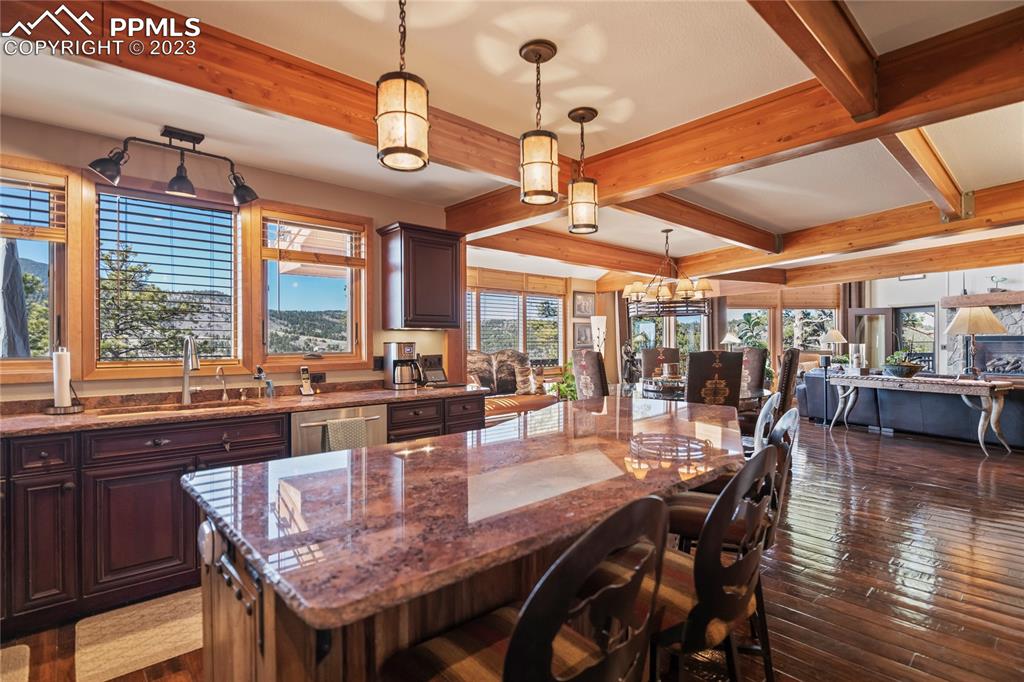 4528 Sheep Patch Road Golden, CO 80403 - Photo 13 of 40 a dining hall with stainless steel appliances granite countertop a dining table and chairs with wooden floor