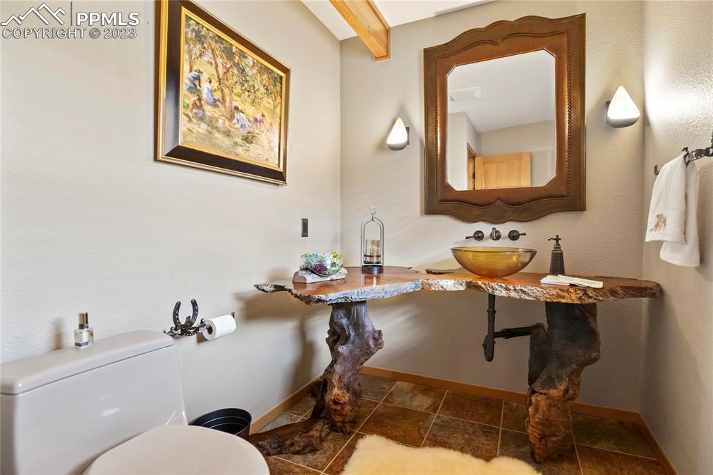 4528 Sheep Patch Road Golden, CO 80403 - Photo 14 of 40 a bathroom with a toilet sink and mirror