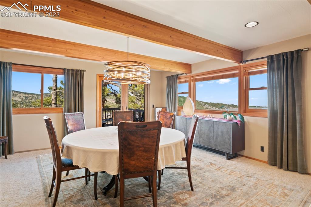 4528 Sheep Patch Road Golden, CO 80403 - Photo 15 of 40 a view of a dining room with furniture window and wooden floor