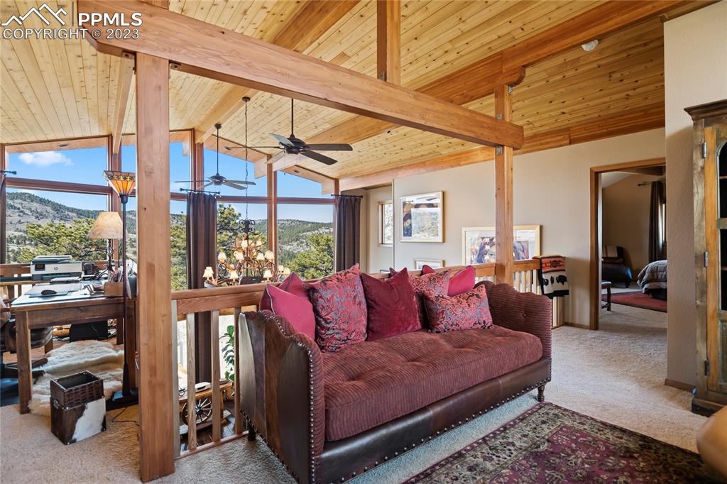 4528 Sheep Patch Road Golden, CO 80403 - Photo 17 of 40 a living room with furniture a floor to ceiling window and a table