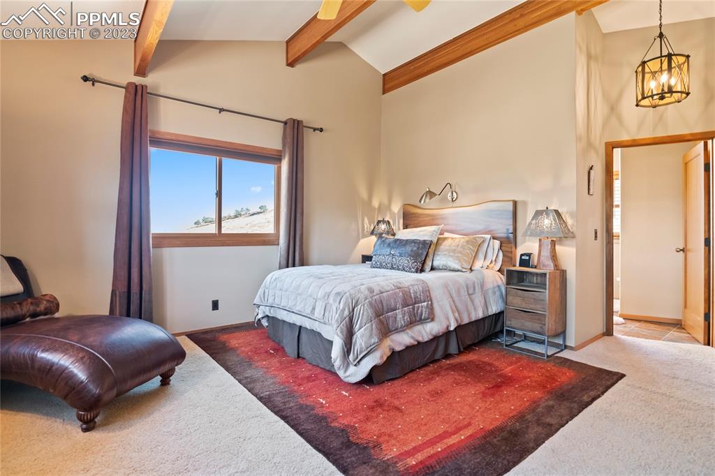 4528 Sheep Patch Road Golden, CO 80403 - Photo 20 of 40 a bedroom with a bed lamp and a window