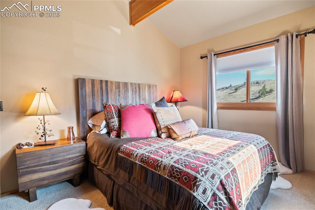 4528 Sheep Patch Road Golden, CO 80403 - Photo 26 of 40 a bedroom with a bed and a painting on the wall