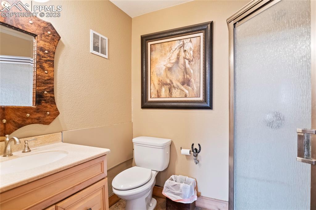 4528 Sheep Patch Road Golden, CO 80403 - Photo 32 of 40 a white toilet sitting next to a bathroom sink