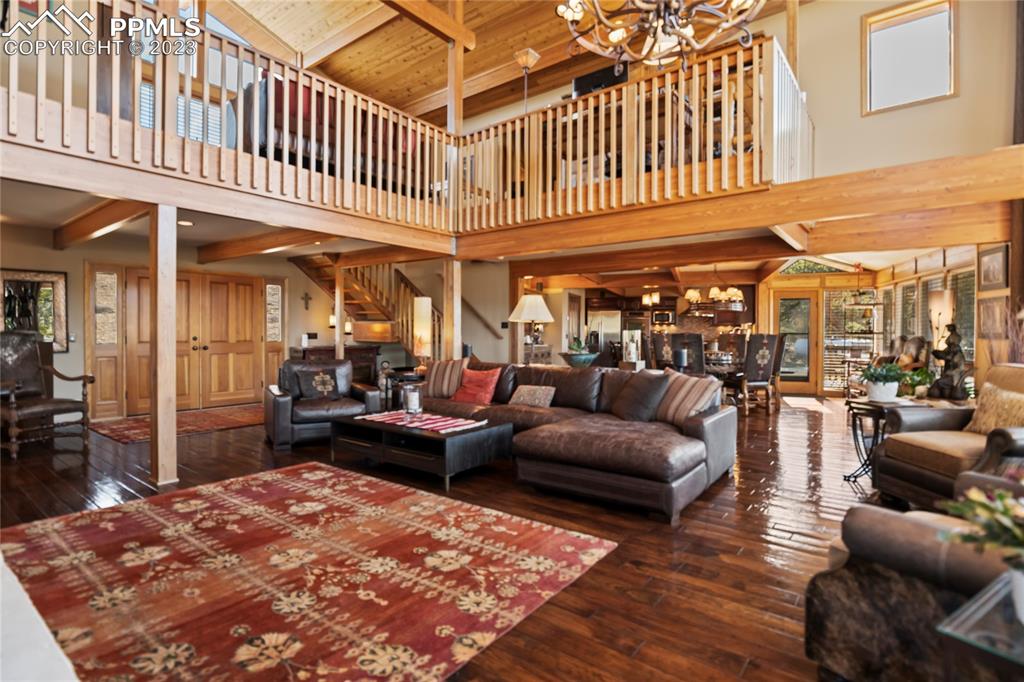 4528 Sheep Patch Road Golden, CO 80403 - Photo 6 of 40 a living room with furniture a rug and a chandelier