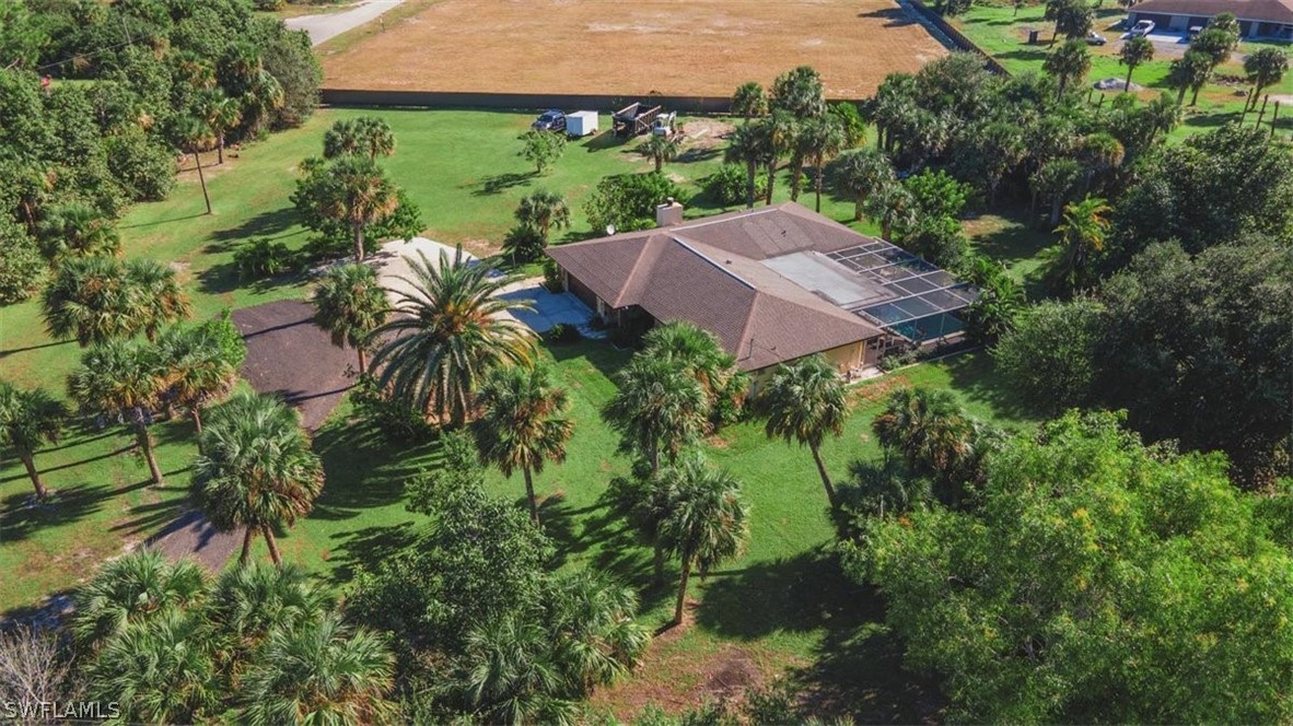an aerial view of house with yard and outdoor seating