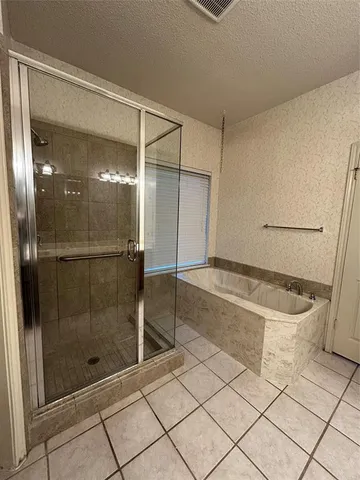 a bathroom with a shower and a bathtub