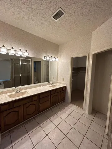 a large bathroom with a double vanity sink and a mirror