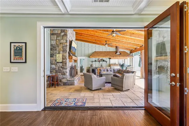 a spacious bedroom with a bed and glass door