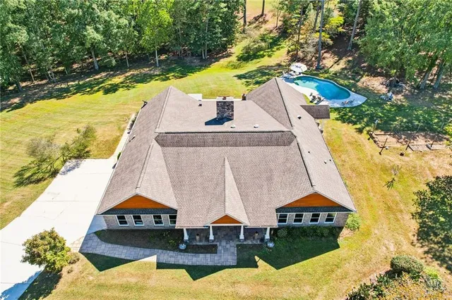 an aerial view of a house with a swimming pool
