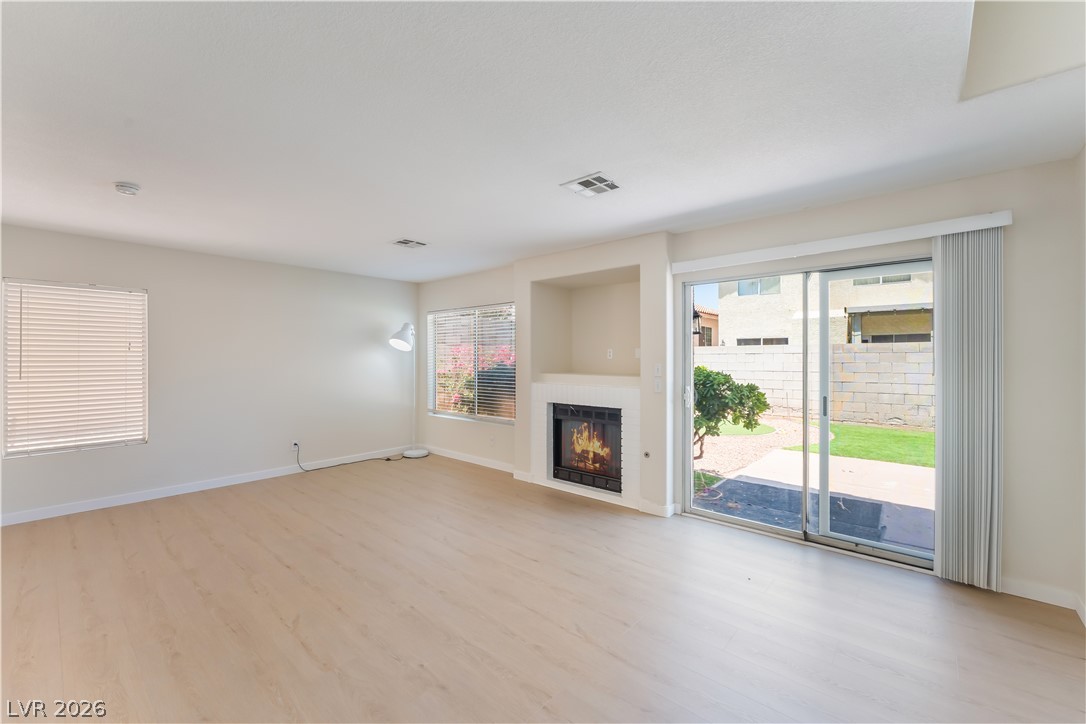 8872 Chapman Point Las Vegas, NV 89129 - Photo 9 of 29 A generously proportioned living area features a charming fireplace and access to the outdoors.