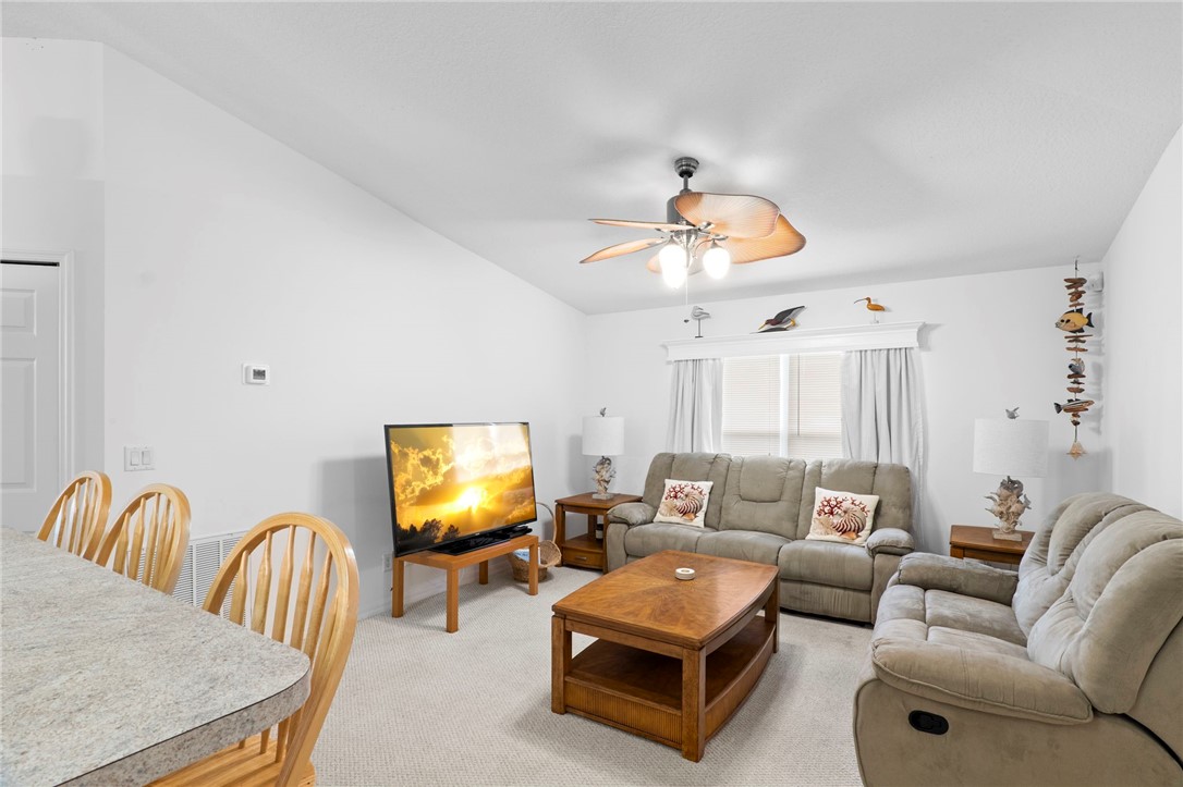 934 Bermuda Avenue Sebastian, FL 32958 - Photo 12 of 31 a living room with furniture and a chandelier