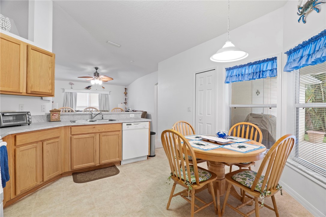 934 Bermuda Avenue Sebastian, FL 32958 - Photo 14 of 31 a kitchen with a dining table chairs and white appliances
