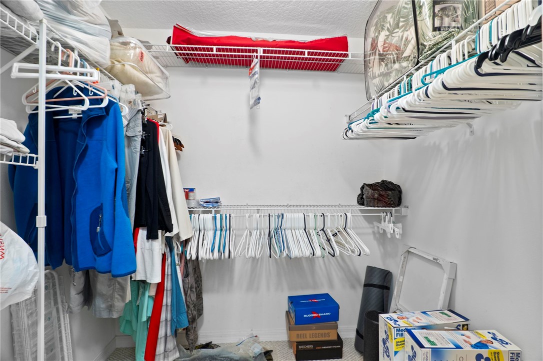 934 Bermuda Avenue Sebastian, FL 32958 - Photo 16 of 31 a view of walk in closet with clothes and shoes