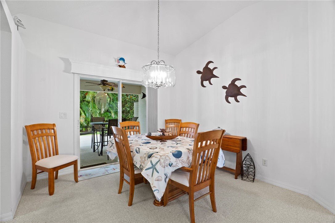 934 Bermuda Avenue Sebastian, FL 32958 - Photo 20 of 31 a dining room with furniture a rug and a chandelier