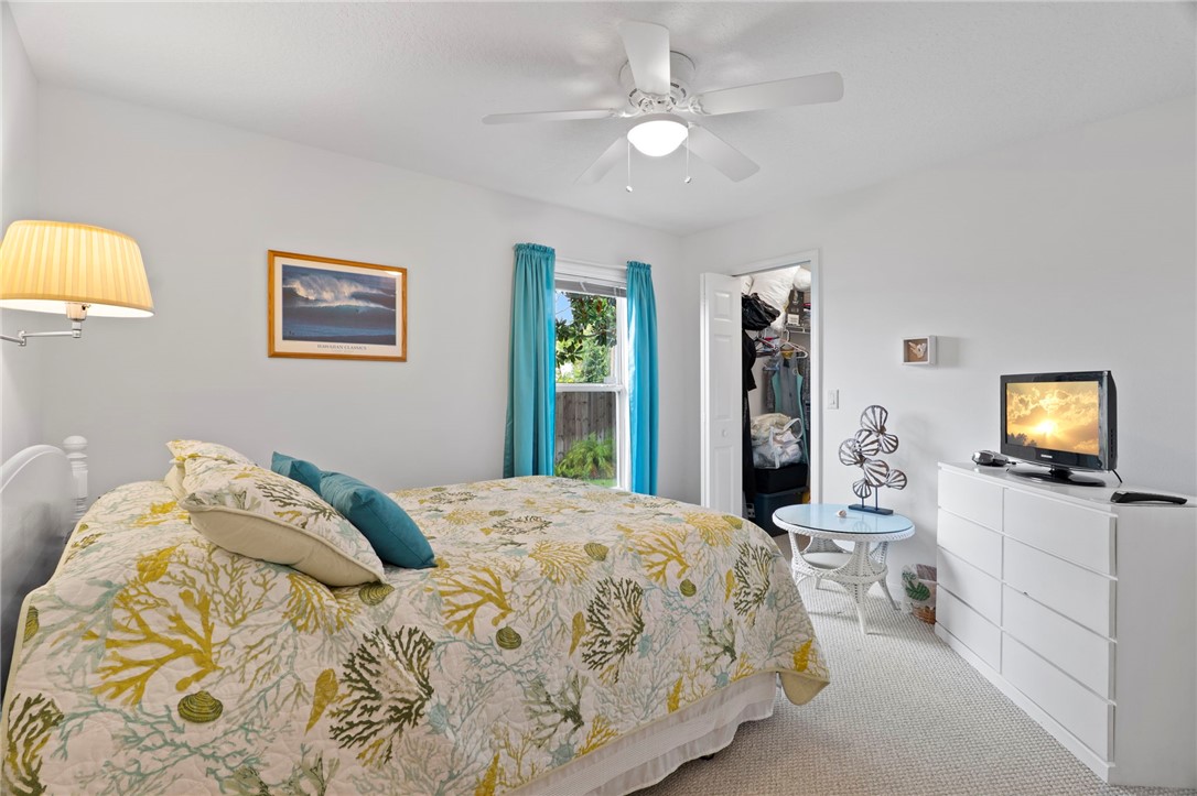 934 Bermuda Avenue Sebastian, FL 32958 - Photo 23 of 31 a bedroom with a bed and a flat screen tv