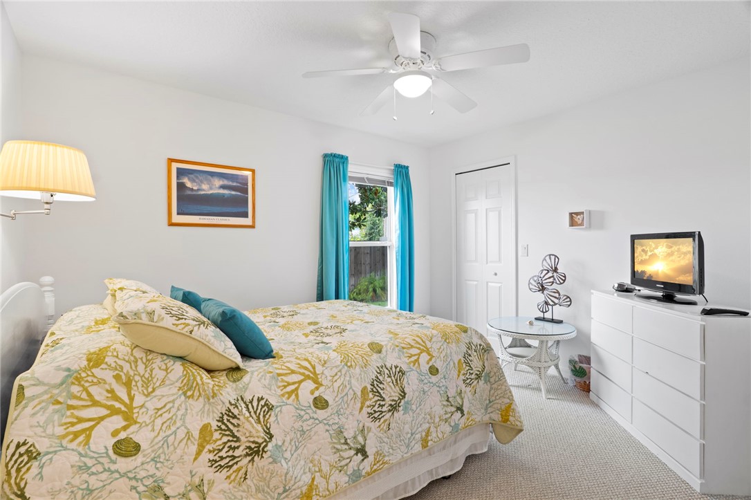 934 Bermuda Avenue Sebastian, FL 32958 - Photo 24 of 31 a bedroom with a bed and a flat screen tv