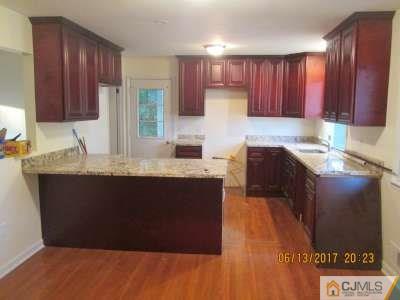 17 Columbia Road Old Bridge, NJ 08859 - Photo 5 of 6 a kitchen with granite countertop a sink stove and cabinets