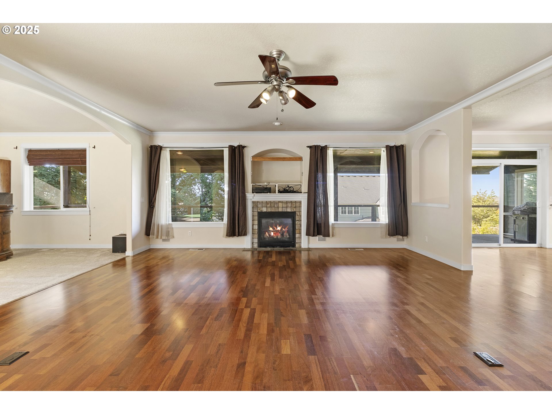 14822 Southeast Natalya Street Happy Valley, OR 97086 - Photo 11 of 48 an empty room with wooden floor fireplace and windows