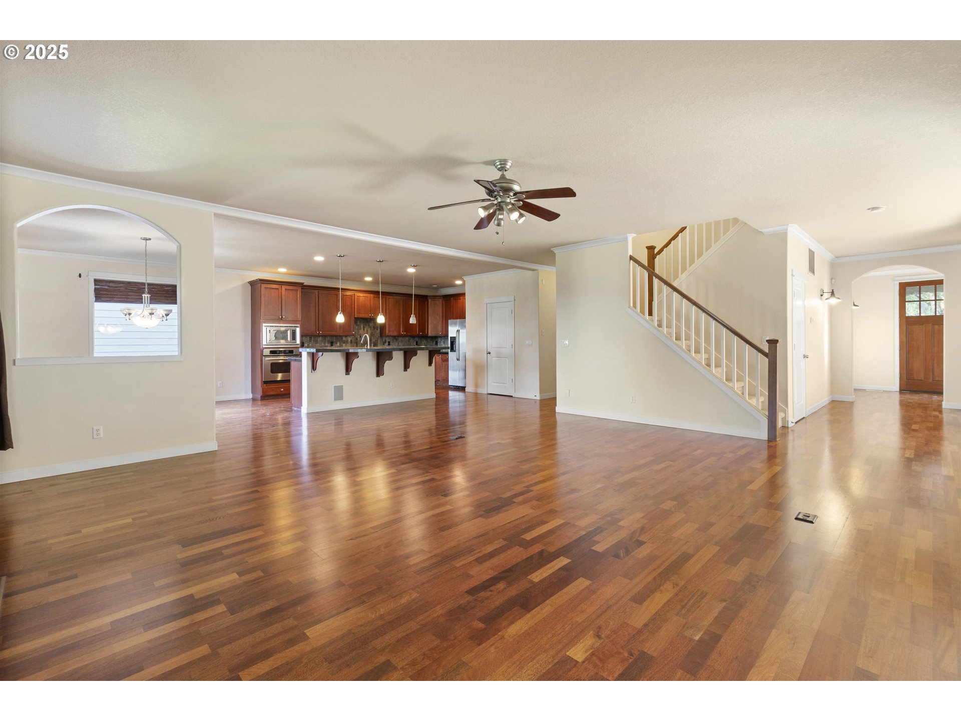 14822 Southeast Natalya Street Happy Valley, OR 97086 - Photo 13 of 48 a view of an empty room with wooden floor and a ceiling fan