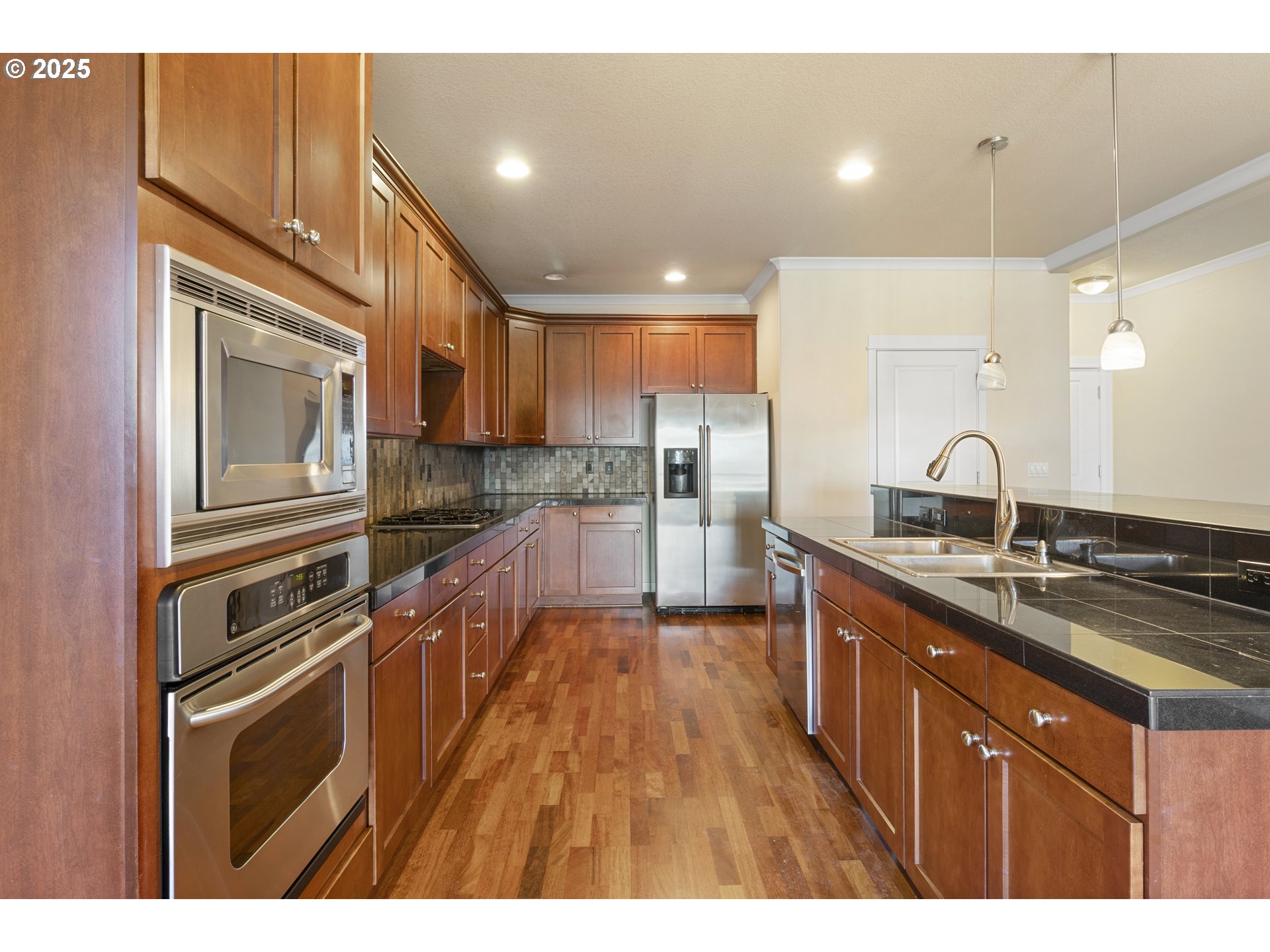 14822 Southeast Natalya Street Happy Valley, OR 97086 - Photo 16 of 48 a kitchen with stainless steel appliances granite countertop a sink stove and refrigerator