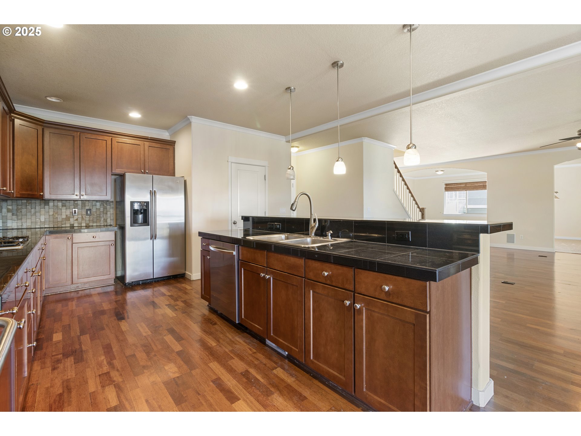 14822 Southeast Natalya Street Happy Valley, OR 97086 - Photo 17 of 48 a kitchen with granite countertop a sink and refrigerator