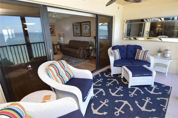 a bedroom with a bed a mirror on dresser and a chandelier