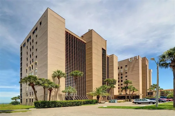 a kitchen with a refrigerator a stove a sink dishwasher and wooden cabinets with wooden floor