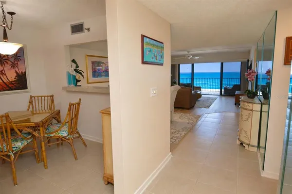 a kitchen with stainless steel appliances granite countertop a refrigerator a sink a stove and white cabinets