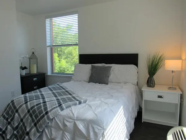 a bedroom with a bed and a window