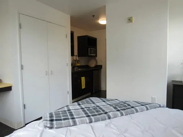 a bedroom with a bed and a television