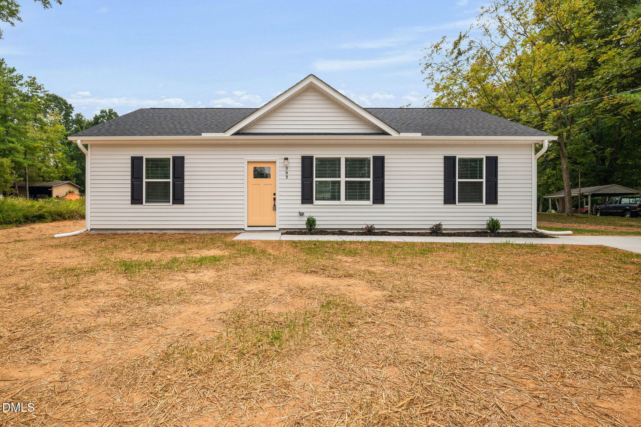 305 West Barden Street Roxboro, NC 27573 - Photo 1 of 31 a front view of house with yard and trees in the background