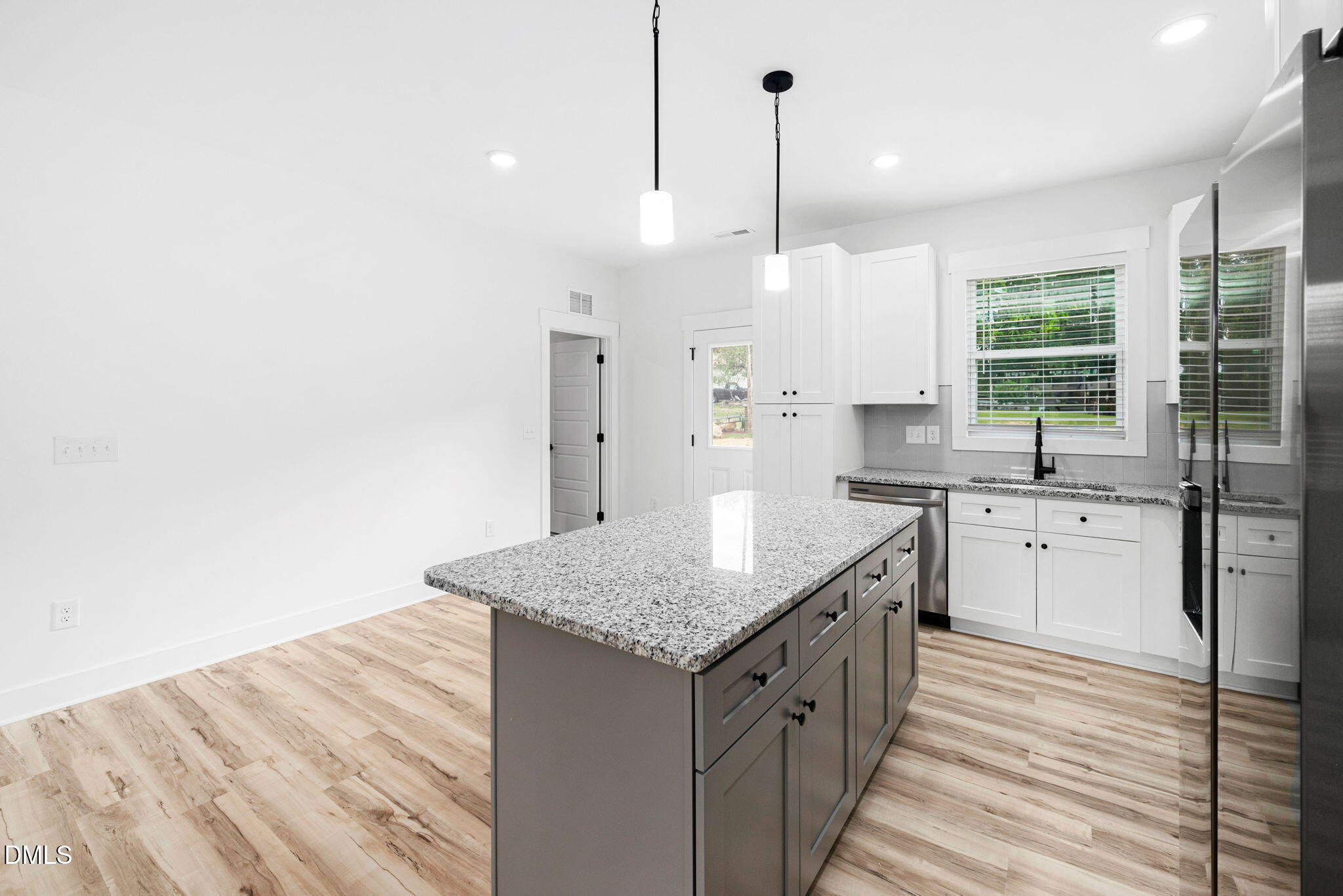 305 West Barden Street Roxboro, NC 27573 - Photo 12 of 31 a kitchen with a sink stove and cabinets