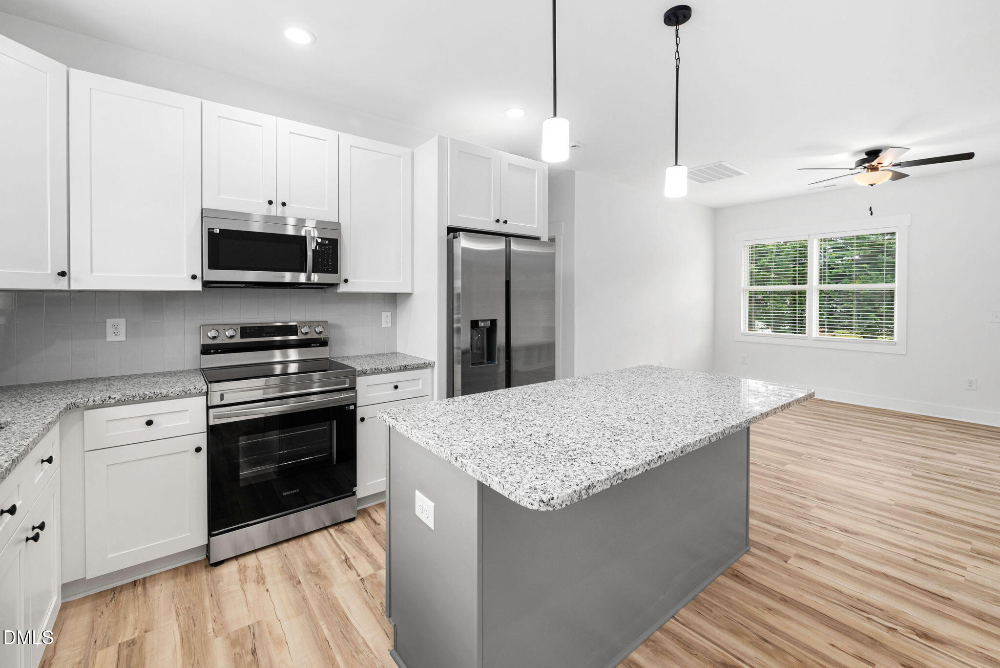 305 West Barden Street Roxboro, NC 27573 - Photo 14 of 31 a kitchen with stainless steel appliances granite countertop a stove a refrigerator and a sink