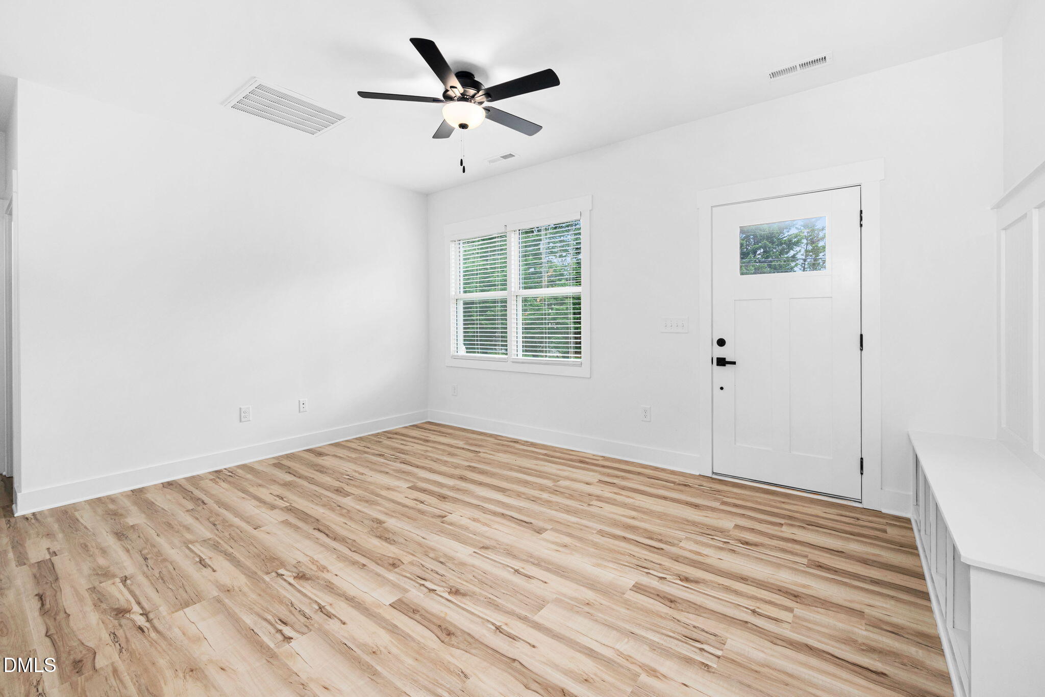 305 West Barden Street Roxboro, NC 27573 - Photo 8 of 31 an empty room with wooden floor fan and windows