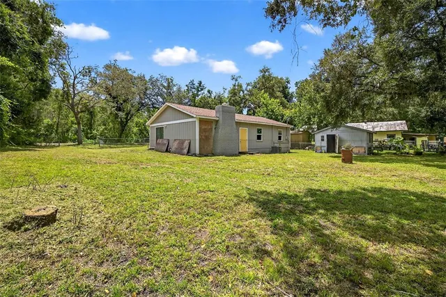 a view of a house with yard and sitting area