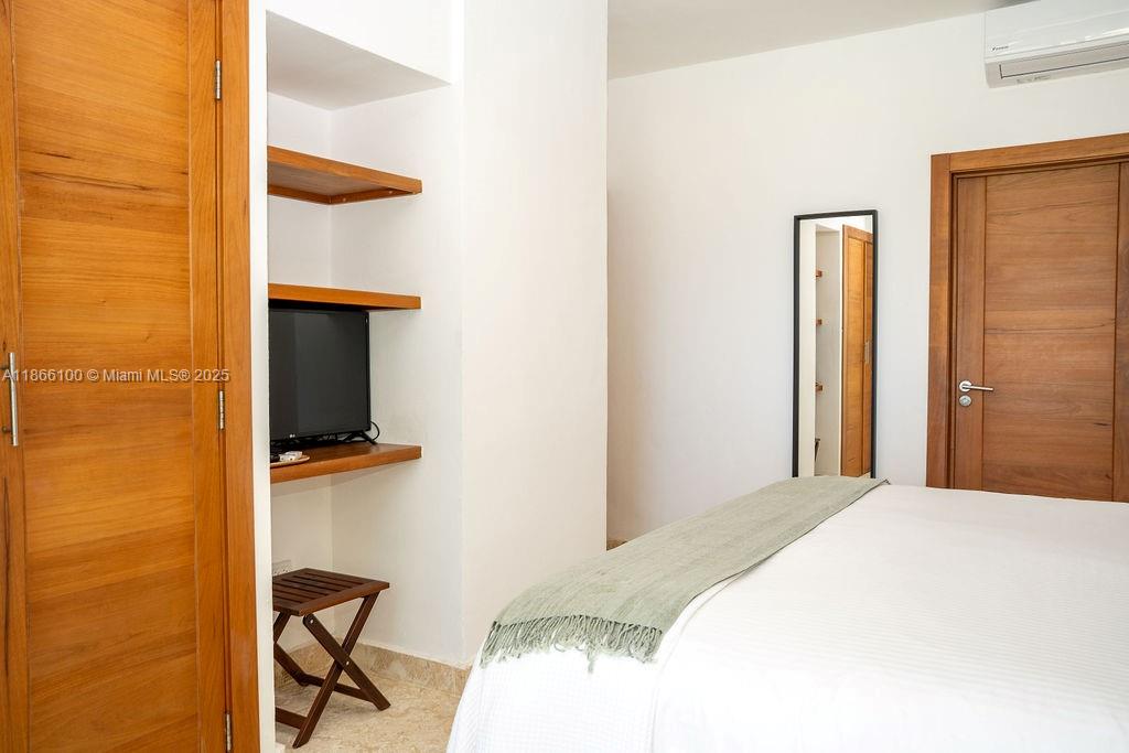 0 8c3f Q62 Las Terrenas Drive, Unit 2 Las Terrenas, Samaná Province 32000 - Photo 12 of 38 a bedroom with a bed and a flat screen tv