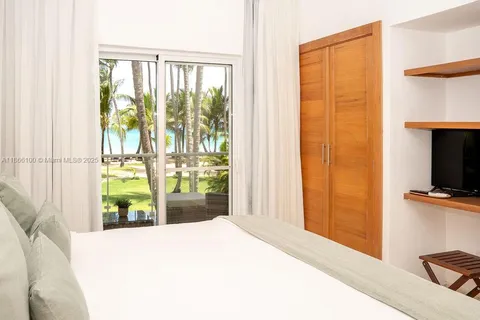 a bedroom with a bed and a television