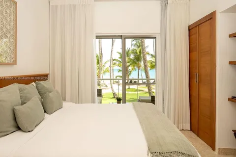 a bedroom with a bed and large window