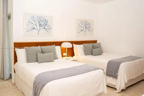 a bedroom with bed and painting on the wall