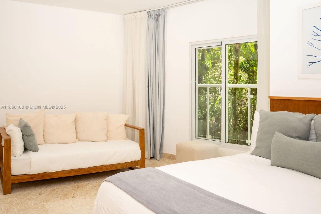 0 8c3f Q62 Las Terrenas Drive, Unit 2 Las Terrenas, Samaná Province 32000 - Photo 21 of 38 a bedroom with furniture and a large window