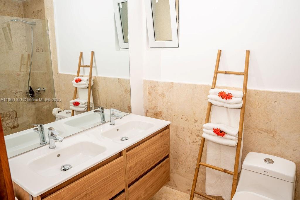 0 8c3f Q62 Las Terrenas Drive, Unit 2 Las Terrenas, Samaná Province 32000 - Photo 25 of 38 a bathroom with a sink and a mirror
