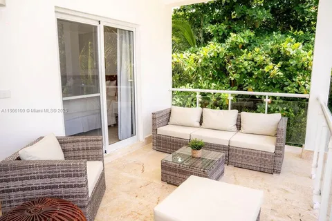 a balcony with furniture and a potted plant