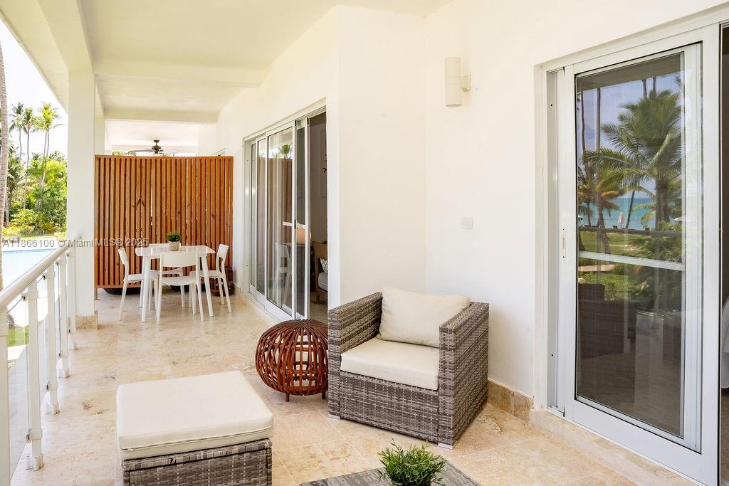 0 8c3f Q62 Las Terrenas Drive, Unit 2 Las Terrenas, Samaná Province 32000 - Photo 31 of 38 a dining room with furniture and a floor to ceiling window