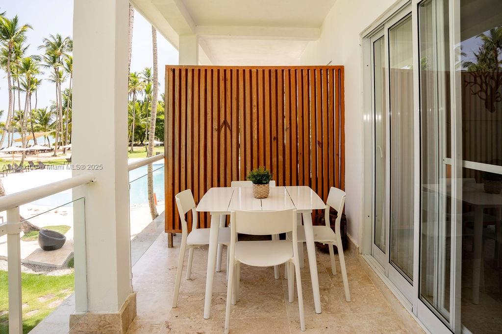 0 8c3f Q62 Las Terrenas Drive, Unit 2 Las Terrenas, Samaná Province 32000 - Photo 32 of 38 a view of a dining room with furniture and a window