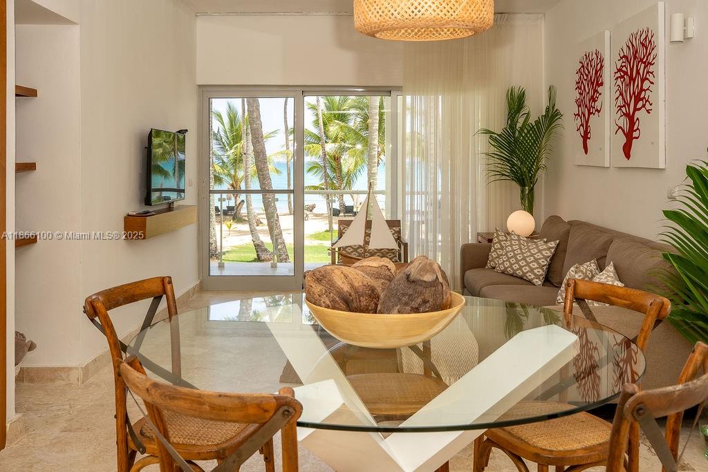 0 8c3f Q62 Las Terrenas Drive, Unit 2 Las Terrenas, Samaná Province 32000 - Photo 4 of 38 a living room with furniture and a large window